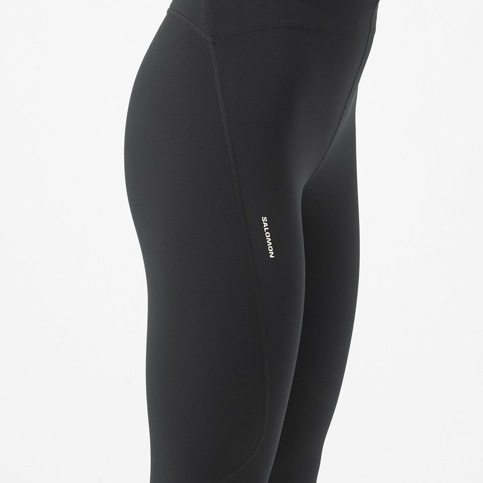Side view of a model wearing the Salomon Women's Shakeout Core Tights 26