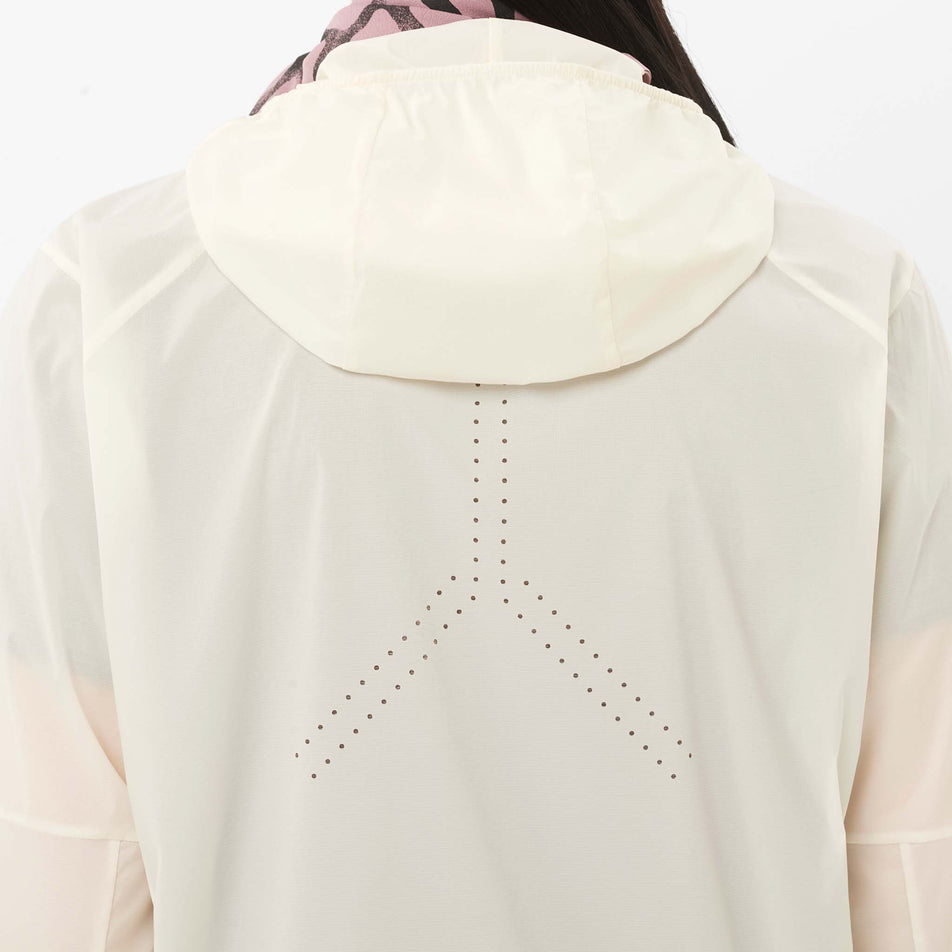 Back view of a model wearing the Salomon Women's Sense Aero Wind Jacket in the Whisper White colourway.