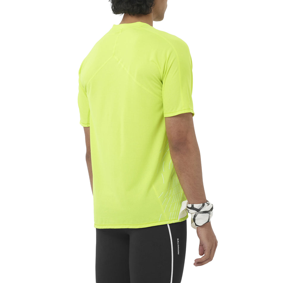 Back view of a model wearing the Salomon Men's Sense Aero SS Tee GFX in the Acid Lime/Butterfly colourway.