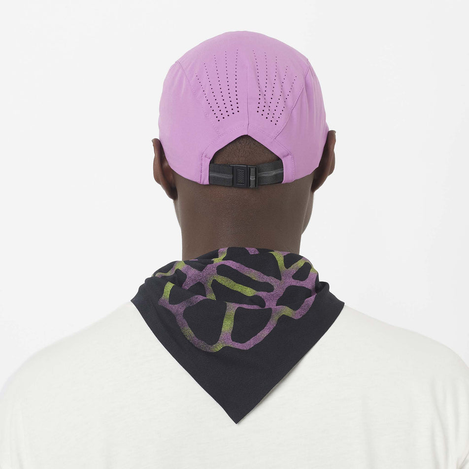 Back view of a model wearing the Salomon Unisex Shakeout Cap in the Iris Orchid colourway.