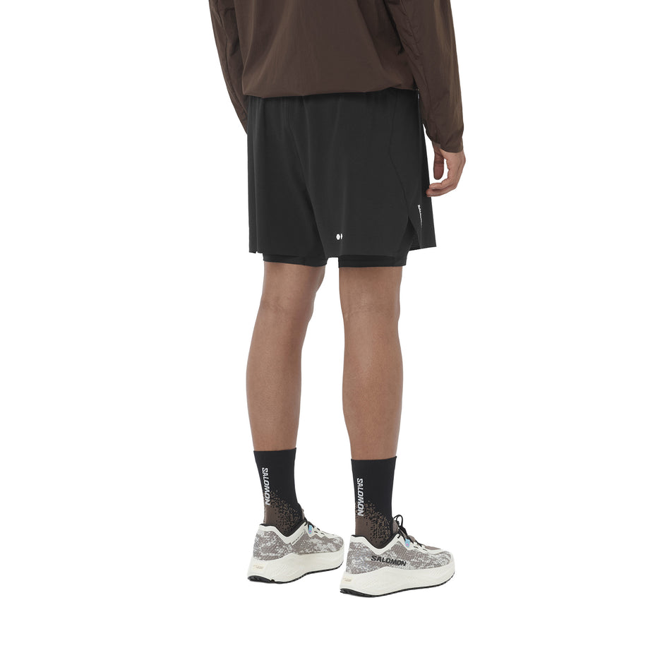 Back view of a model wearing the Salomon Men's Sense Aero 2in1 Trail Shorts 5