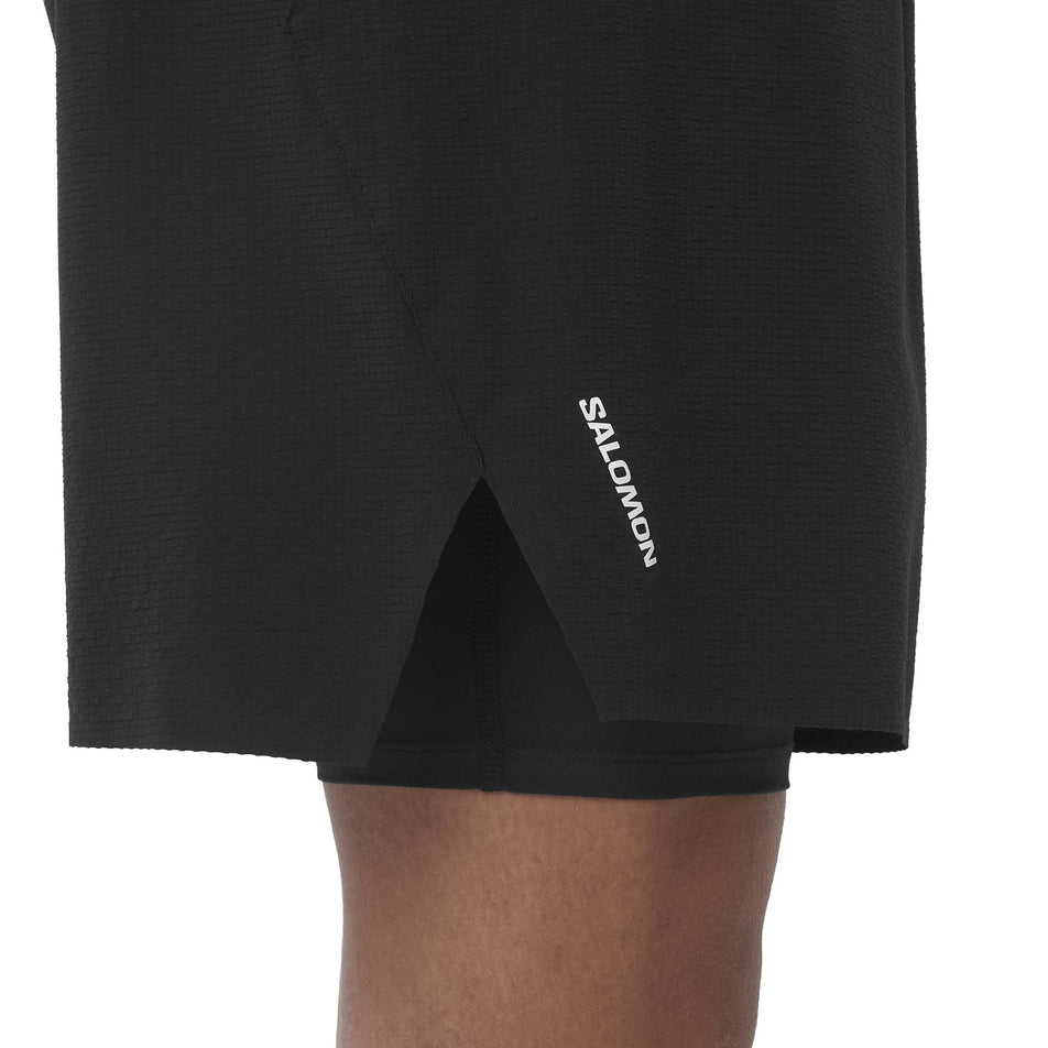 Side view of a model wearing the Salomon Men's Sense Aero 2in1 Trail Shorts 5