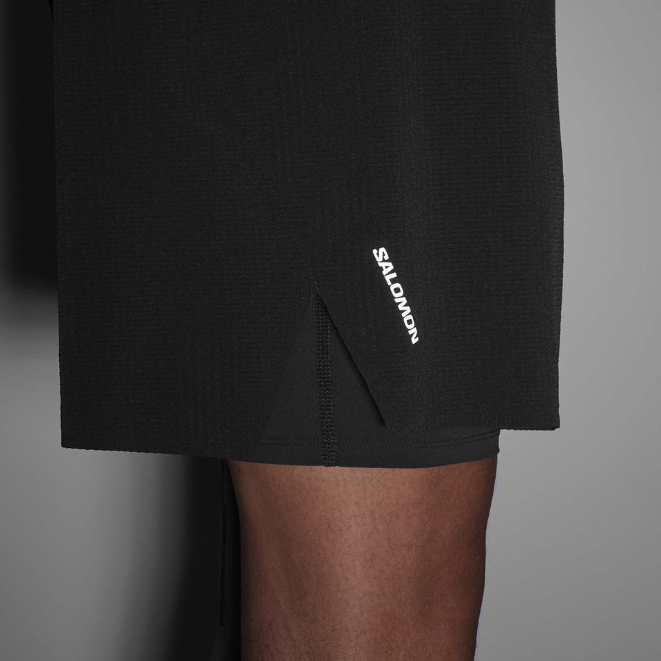 Side view of a model wearing the Salomon Men's Sense Aero 2in1 Trail Shorts 5