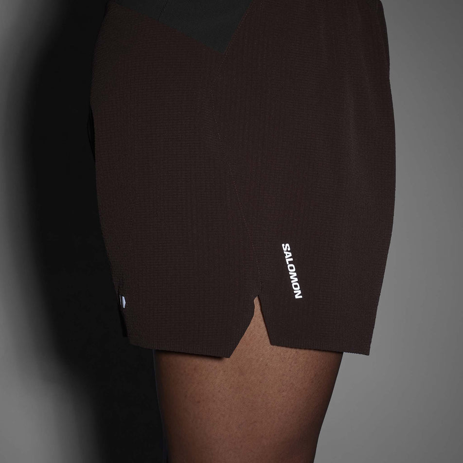 Side view of a model wearing Salomon Men's Sense Aero Stow 5