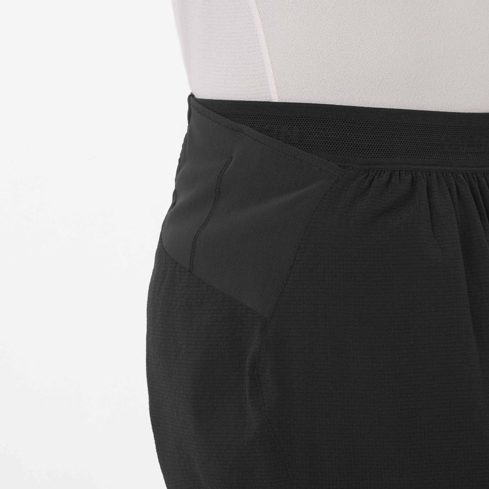 Side view of a model wearing the Salomon Men's Sense Aero Stow 5