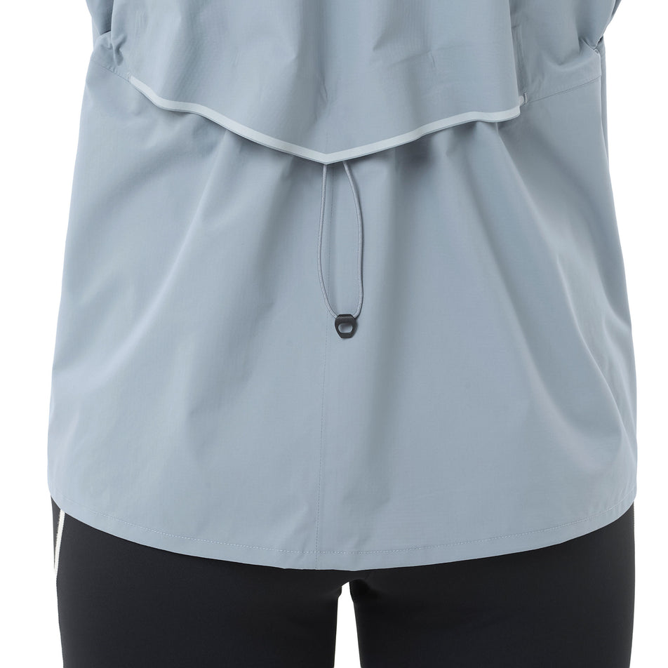 Back view of a model wearing the Salomon Women's Bonatti Waterproof Jacket in the Trade Winds colourway.