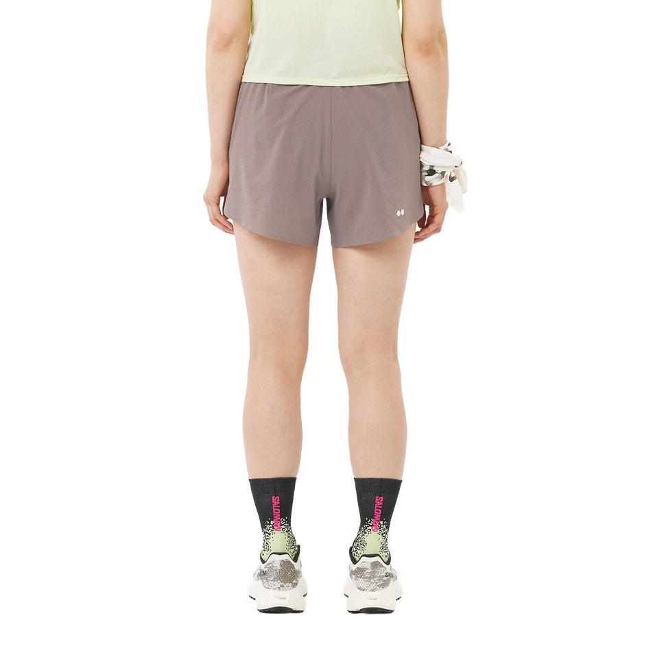 Back view of a model wearing the Salomon Women's Sense Aero Stow 4