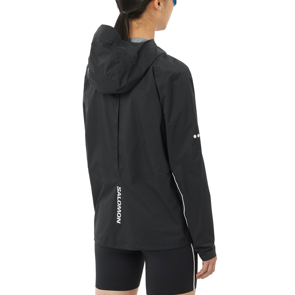 Back view of a model wearing the Salomon Women's Bonatti Pro Shell Jacket in the Deep Black colourway.