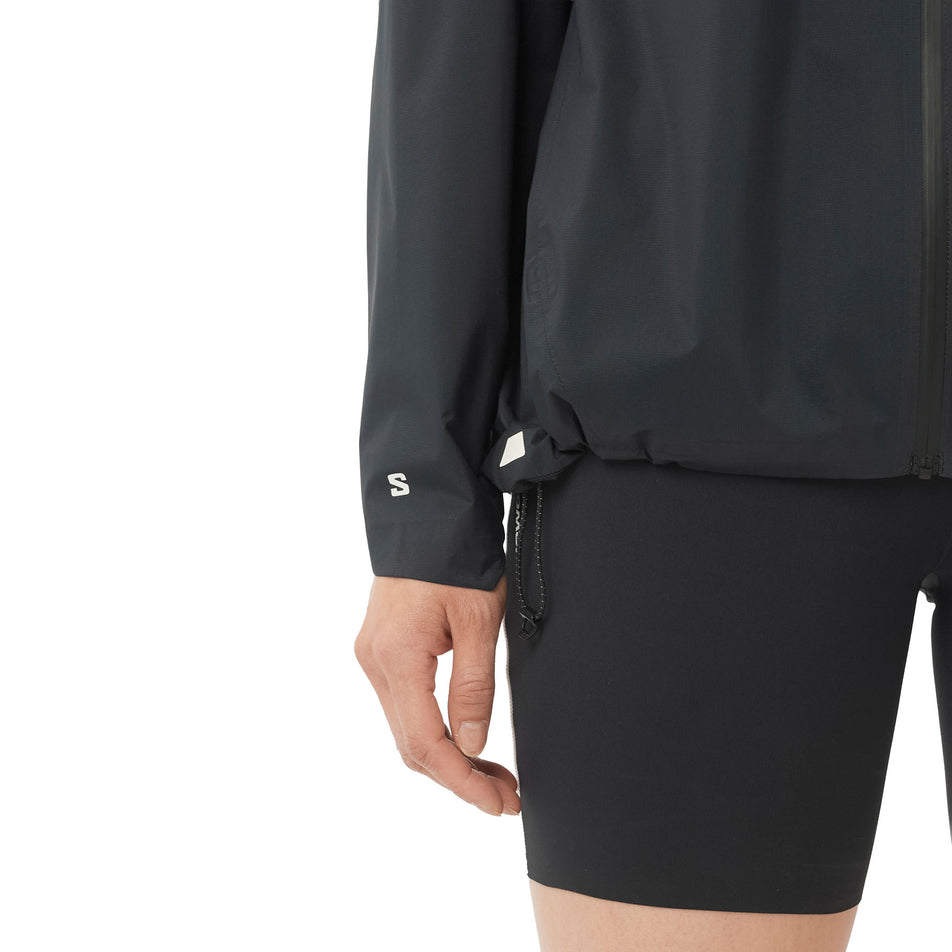 Front view of a model wearing the Salomon Women's Bonatti Pro Shell Jacket in the Deep Black colourway.