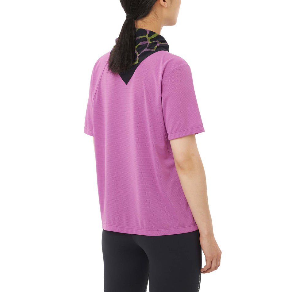 Back view of a model wearing the Salomon Women's SHKout Core SS Tee in the Iris Orchid colourway.
