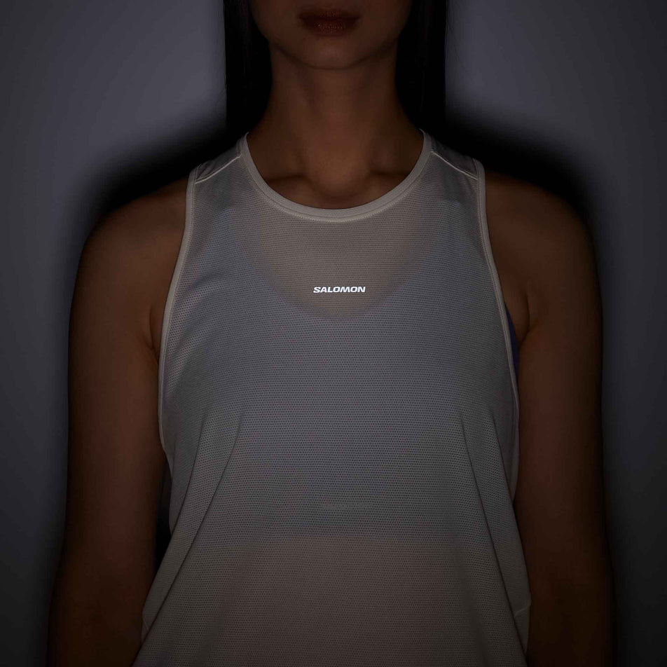 Front view of a model wearing the Salomon Women's Shakeout Core Tank in the Whisper White colourway.