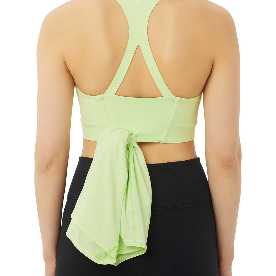 Back view of a model wearing the Salomon Women's SHKout Bliss Bra in the Butterfly colourway.