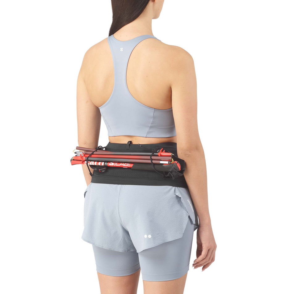 Running poles stowed on the Salomon Unisex ADV Skin Seamless Belt in the Black/White colourway.