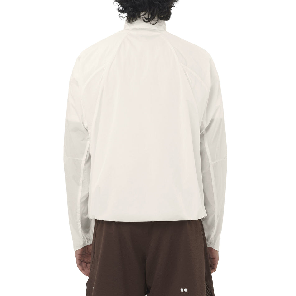 Back view of a model wearing the Salomon Men's SHKout Fly Jacket in the Whisper White colourway.