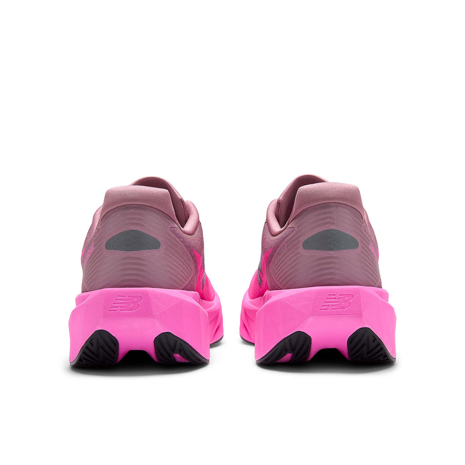 The back of a pair of New Balance Men's Fuelcell Rebel V5 Running Shoes in the Pink Heat/Rosewood colourway.