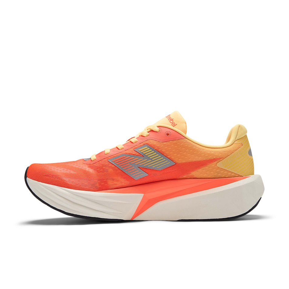 Medial view of right shoe from a pair of New Balance Men's Fuelcell Rebel V5 Running Shoes in the Tangerine Heat colourway.