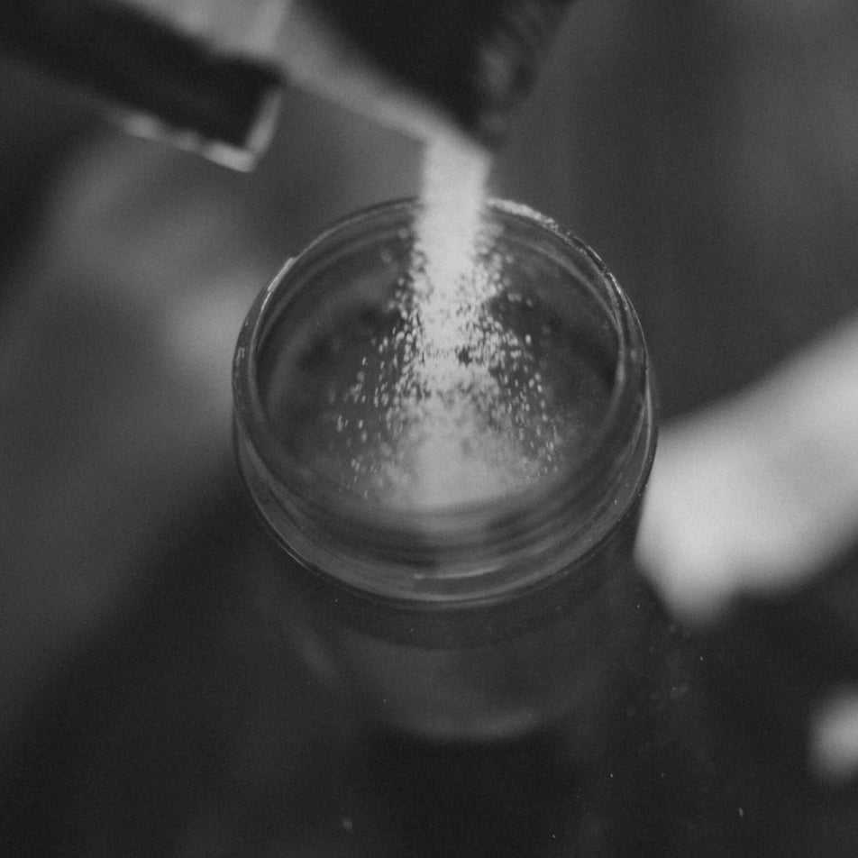 A water bottle being filled with Maurten Drink Mix. (7077097504930)