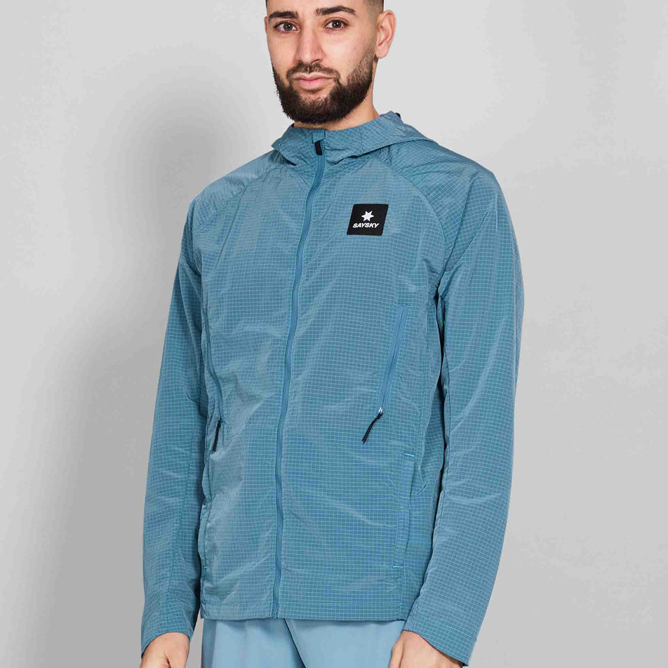 Front view of a model wearing the SAYSKY Men's Clean Pace Shield Jacket in the Blue colourway. (8601240633506)