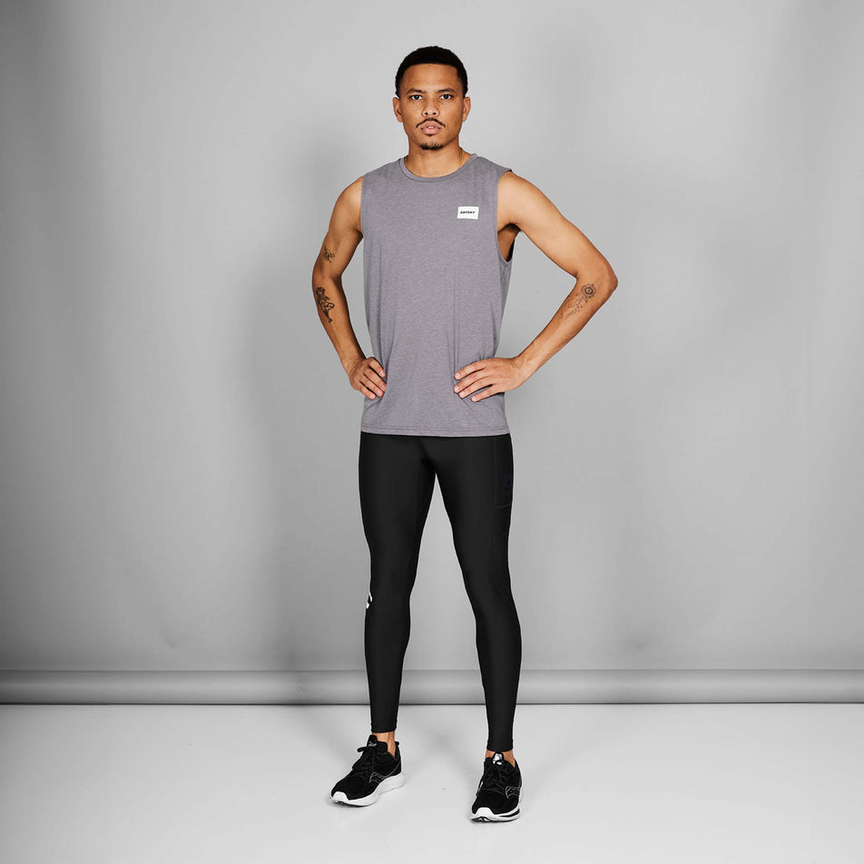 Front view of a model wearing a pair of the SAYSKY Men's Logo Motion+ Long Tights in the Black colourway. Model is also wearing shoes and a top. (8601278808226)