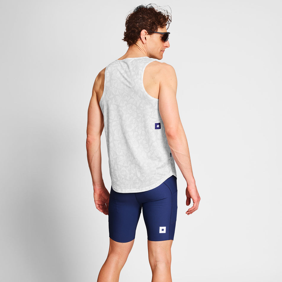 Back view of a model wearing a SAYSKY Men's Flower Combat Singlet in the White AOP colourway. Model is also wearing sunglasses and legwear. (8663031873698)