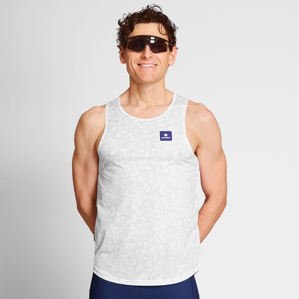 Front view of a model wearing a SAYSKY Men's Flower Combat Singlet in the White AOP colourway. Model is also wearing sunglasses and legwear. (8663031873698)