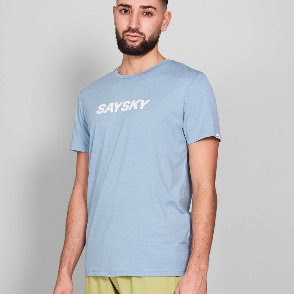 Front view of a model wearing the SAYSKY Men's Logo Pace T-Shirt in the Blue Melange colourway. Model is also wearing shorts.(8601301647522)