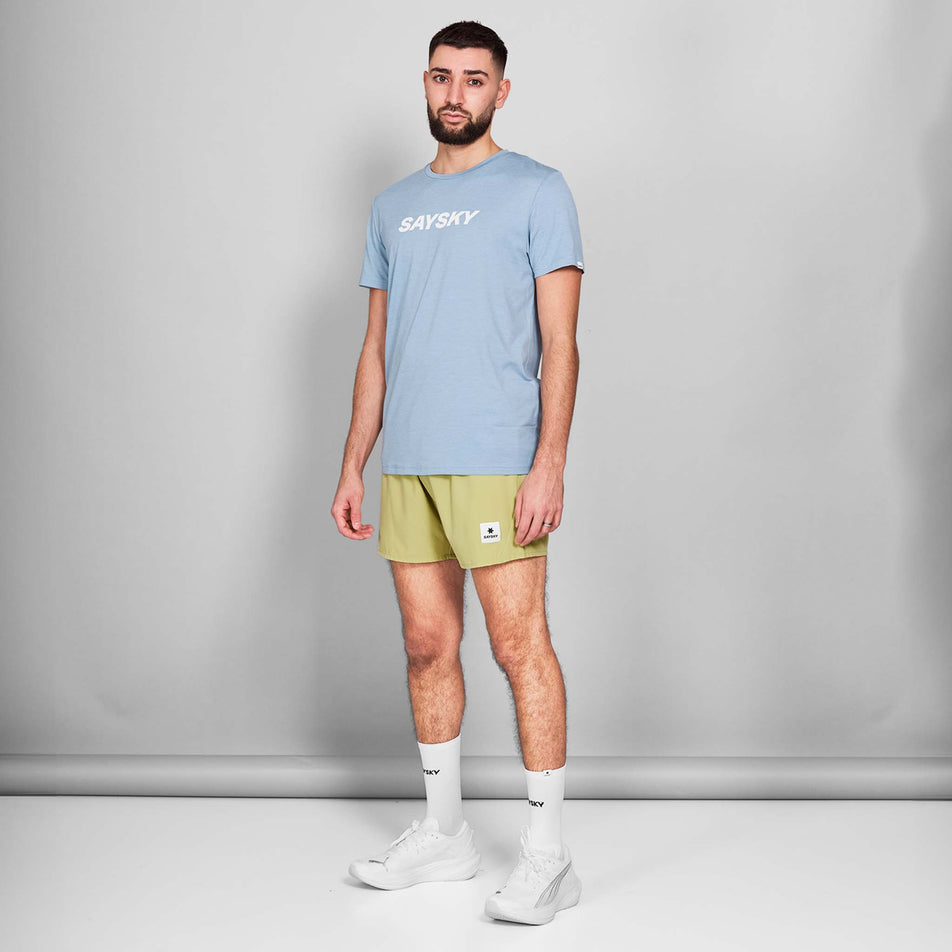 Front view of a model wearing the SAYSKY Men's Logo Pace T-Shirt in the Blue Melange colourway. Model is also wearing shoes, socks and shorts. (8601301647522)