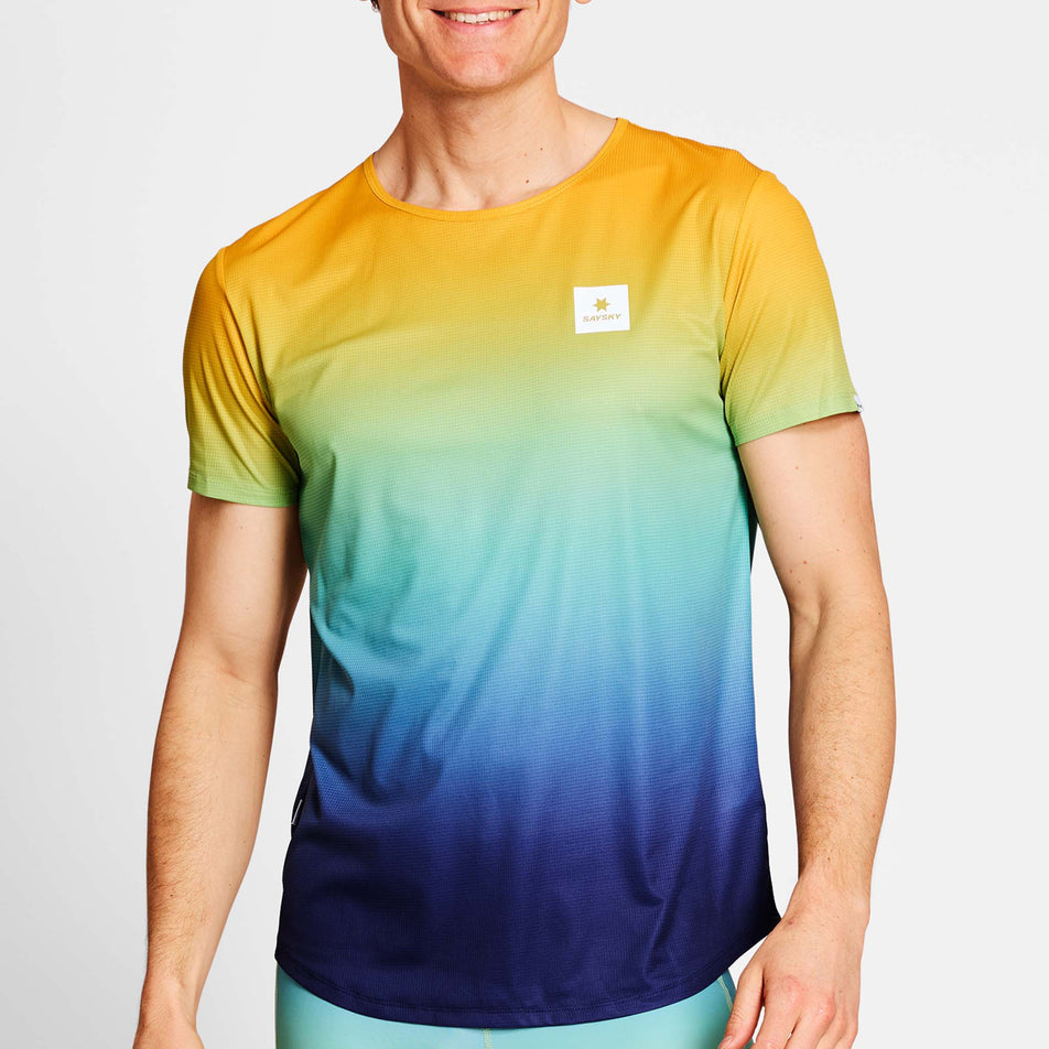 Front view of a model wearing a SAYSKY Men's Drip Dye Flow T-Shirt in the Blue AOP colourway. Model is also wearing legwear. (8675467428002)