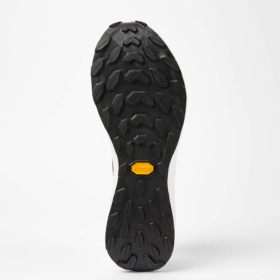 The outsole of the left shoe from a pair of NNormal Unisex Kjerag Trail Running Shoes in the black/grey colourway (7965361569954)