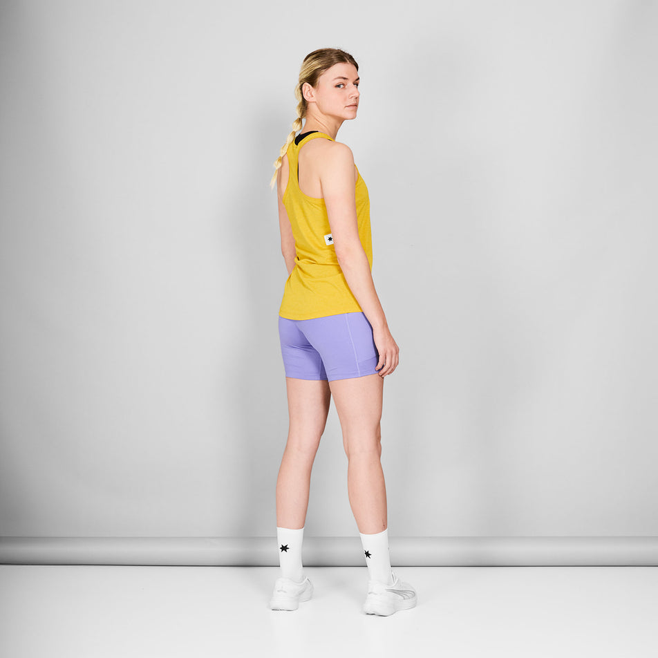 Back view of a model wearing the SAYSKY Women's Logo Combat Pro Singlet in the Yellow colourway. Model is also wearing shorts, socks and shoes. (8602088013986)