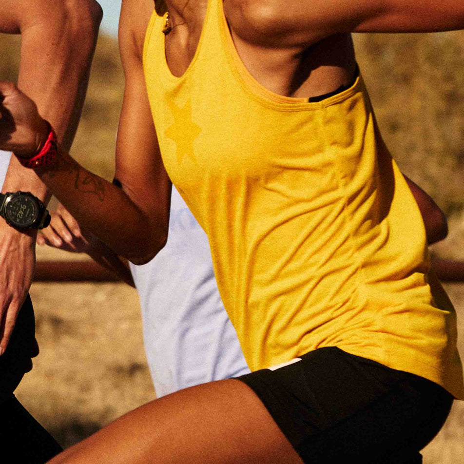 Side view of a model wearing the SAYSKY Women's Logo Combat Pro Singlet in the Yellow colourway. (8602088013986)