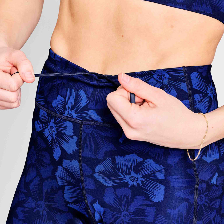 A model demonstrating the drawcord on the waistband of the SAYSKY Women's Flower Combat+ Short Tights 7