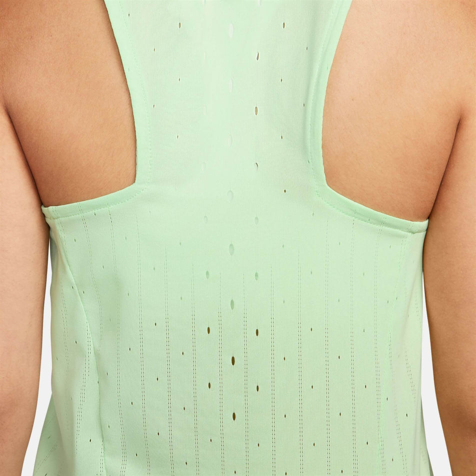 Close-up back view of a model wearing the Women's AeroSwift Dri-FIT ADV Running Singlet in the Vapor Green/Black colourway. (8186003357858)