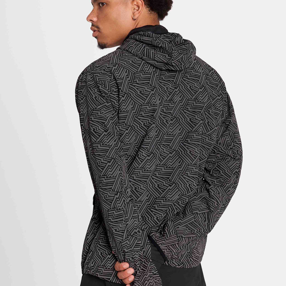 Back view of a model wearing the SAYSKY Men's Reflective Blaze Jacket in the Black colourway. (8787878084770)