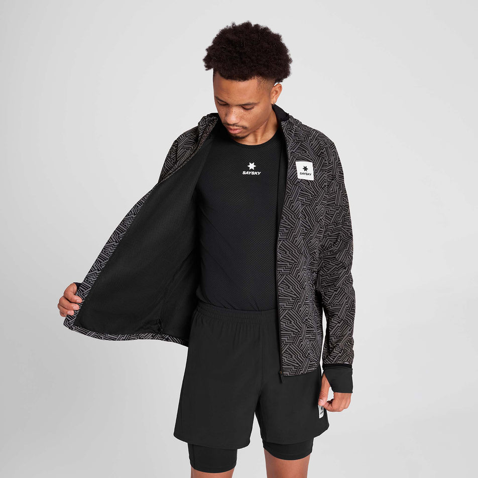 Front view of a model wearing the SAYSKY Men's Reflective Blaze Jacket in the Black colourway. (8787878084770)
