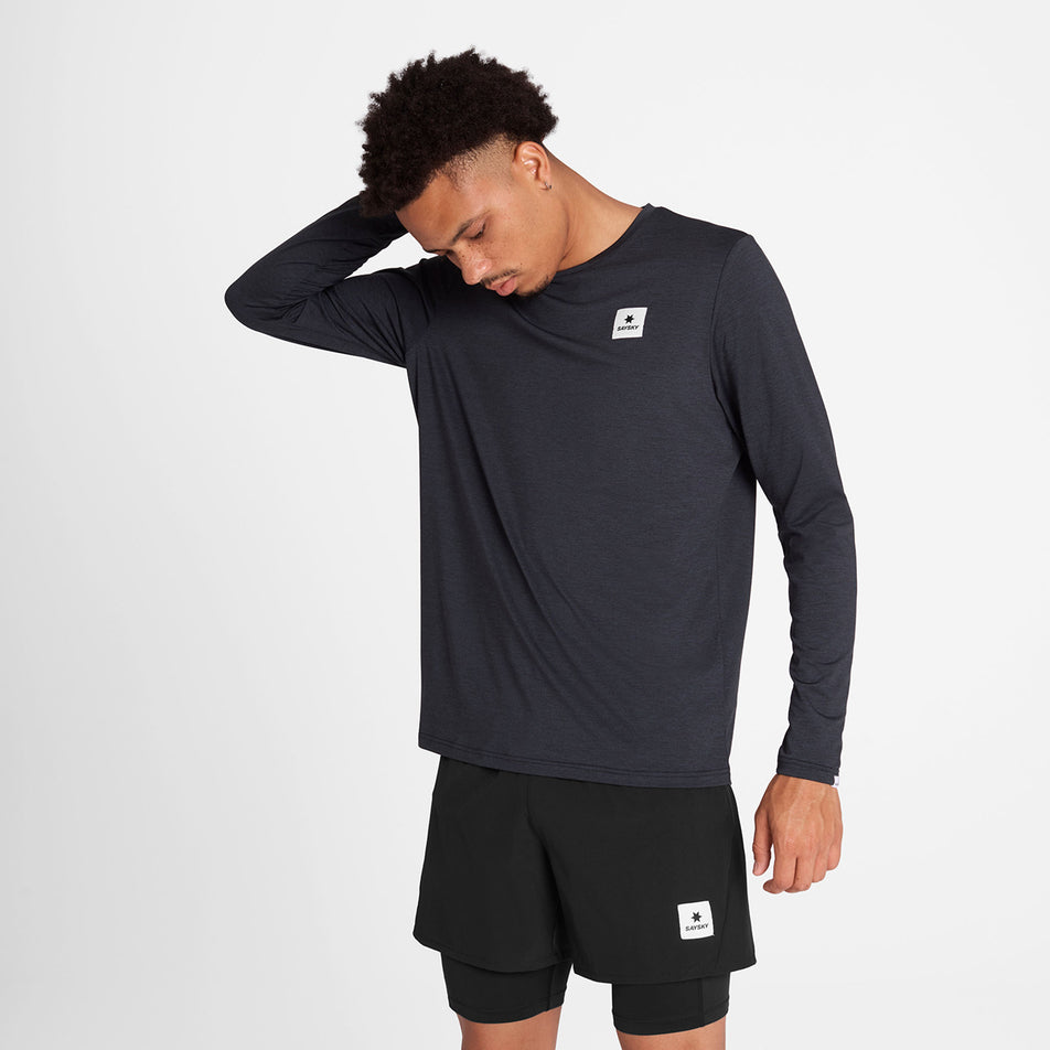 Front view of a model wearing the SAYSKY Men's Reflective Logo Pace Long Sleeve in the Black colourway. (8788224344226)