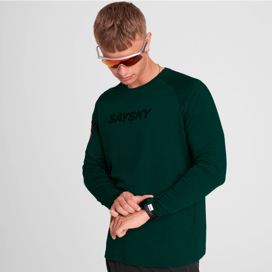 Front view of a model wearing the SAYSKY Men's Logo Pace Long Sleeve in the Green colourway. (8731670249634)