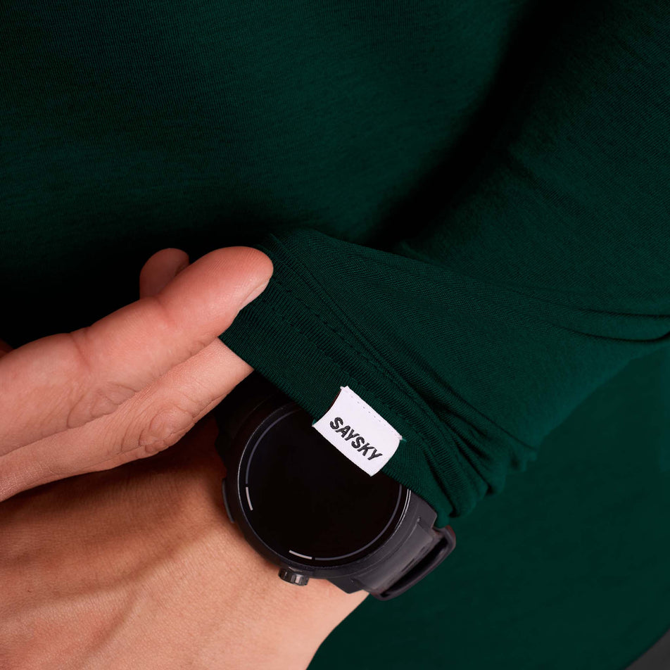 Close-up view of the SAYSKY logo on the sleeve of the SAYSKY Men's Logo Pace Long Sleeve in the Green colourway. (8731670249634)