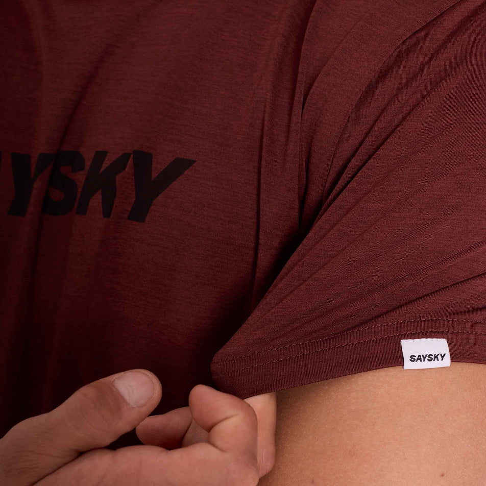 Close-up of the SAYSKY logo on the sleeve of the SAYSKY Men's Logo Pace T-Shirt in the Red colourway. (8731675394210)