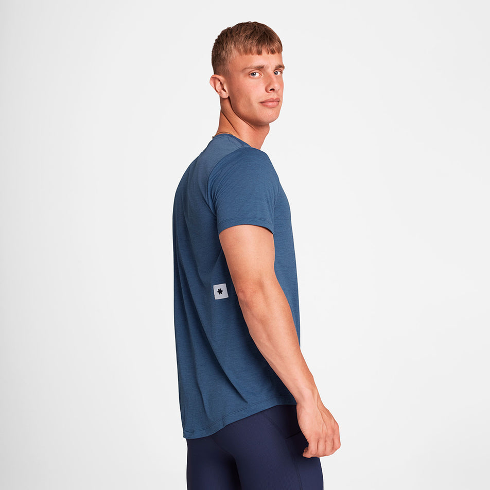 Side view of a model wearing the SAYSKY Logo Combat Pro T-Shirt in the Blue colourway. (8730913669282)