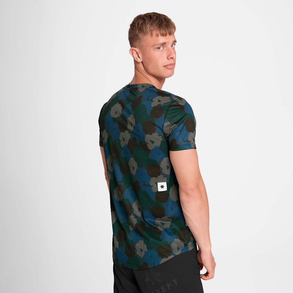 Back view of a model wearing the SAYSKY Men's Flower Combat T-Shirt in the Blue AOP colourway. Model is also wearing shorts. (8756181434530)