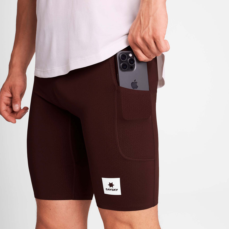 A model demonstrating the drop-in pocket on the side of the SAYSKY Men's Combat+ Short Tights 9