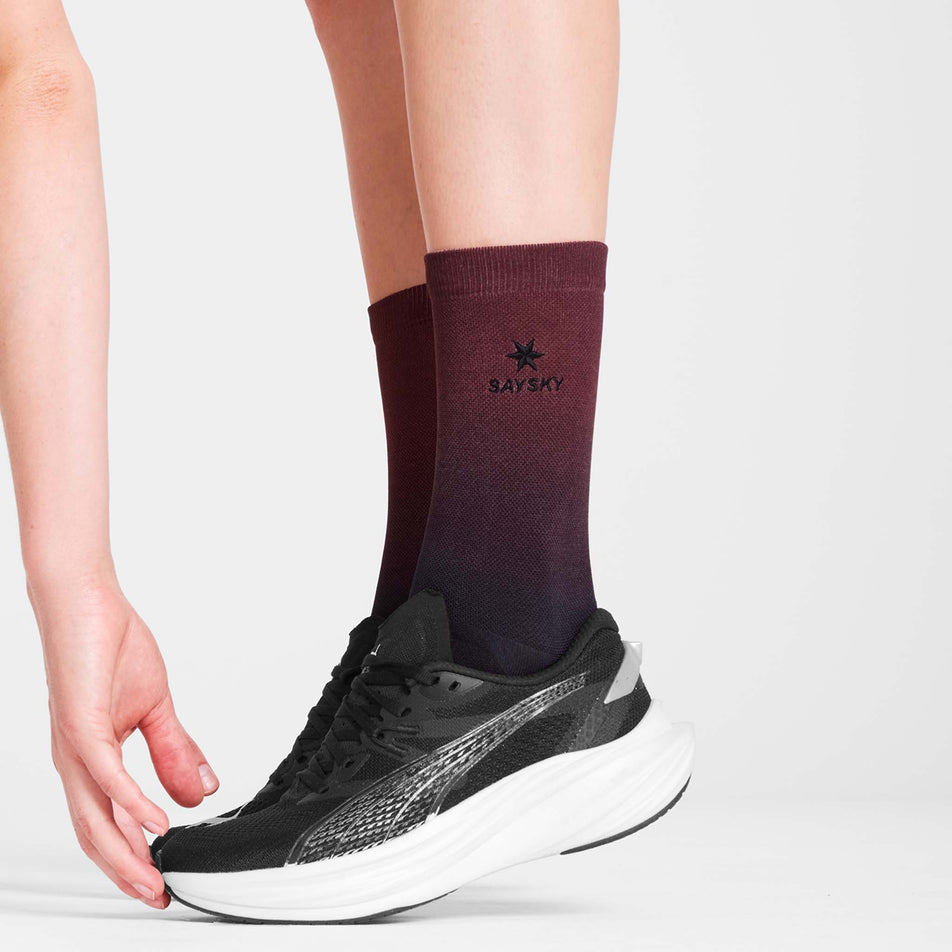 Side view of a model wearing the SAYSKY Unisex Combat Socks in the Red AOP colourway. (8731013415074)