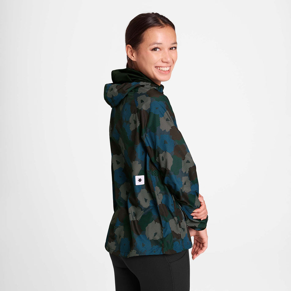 Back view of a model wearing the SAYSKY Women's Flower Pace Jacket in the Blue AOP colourway. Model is also wearing leggings. (8756501971106)