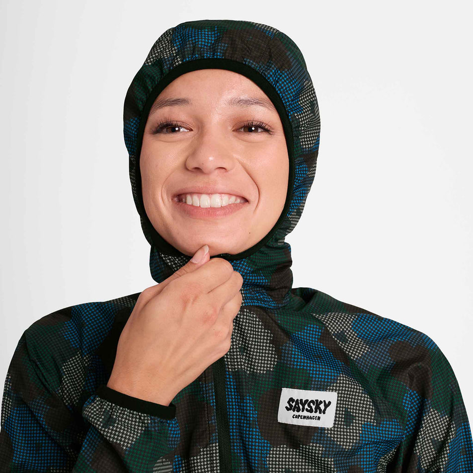 Front view of a model demonstrating the hood on a SAYSKY Women's Flower Pace Jacket in the Blue AOP colourway. Jacket is being worn by a model. (8756501971106)