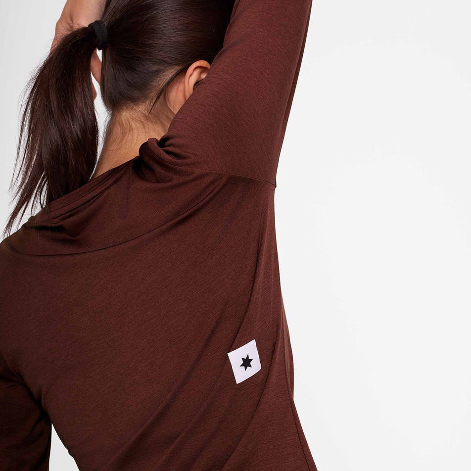 Back view of a model wearing the SAYSKY Women's Logo Pace Long Sleeve in the Red colourway. (8731667792034)