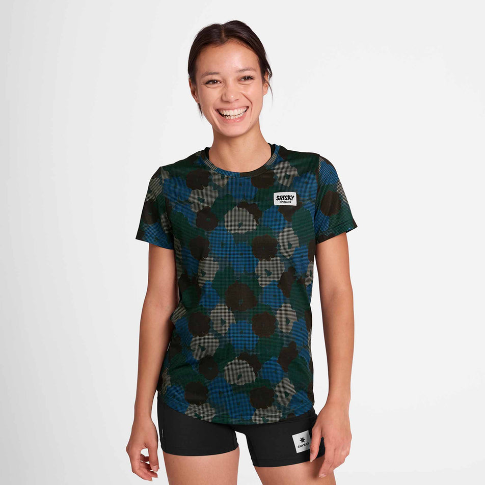 Front view of a model wearing the SAYSKY Women's Flower Combat T-Shirt in the Blue AOP colourway. Model is also wearing short tights. (8756513570978)