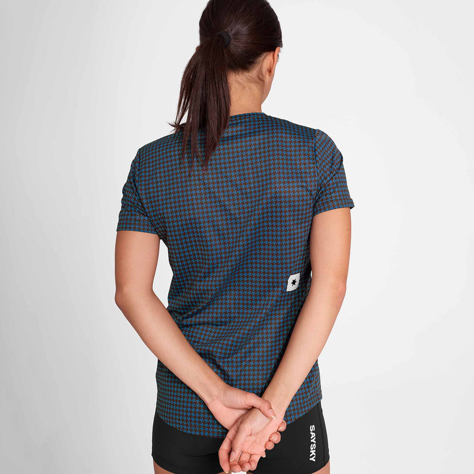 Back view of a model wearing the SAYSKY Women's Houndstooth Combat T-Shirt in the Blue AOP colourway. Model is also wearing short tights. (8756514783394)