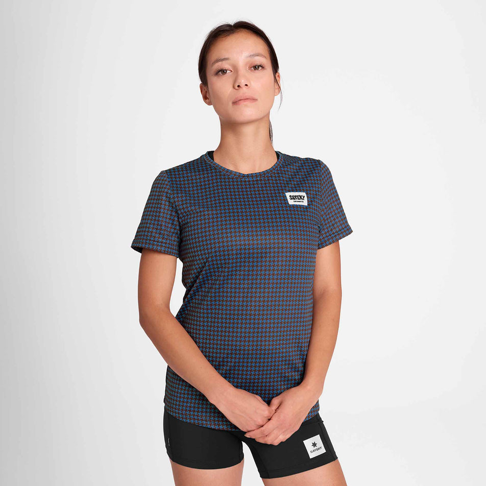 Front view of a model wearing the SAYSKY Women's Houndstooth Combat T-Shirt in the Blue AOP colourway. Model is also wearing short tights. (8756514783394)