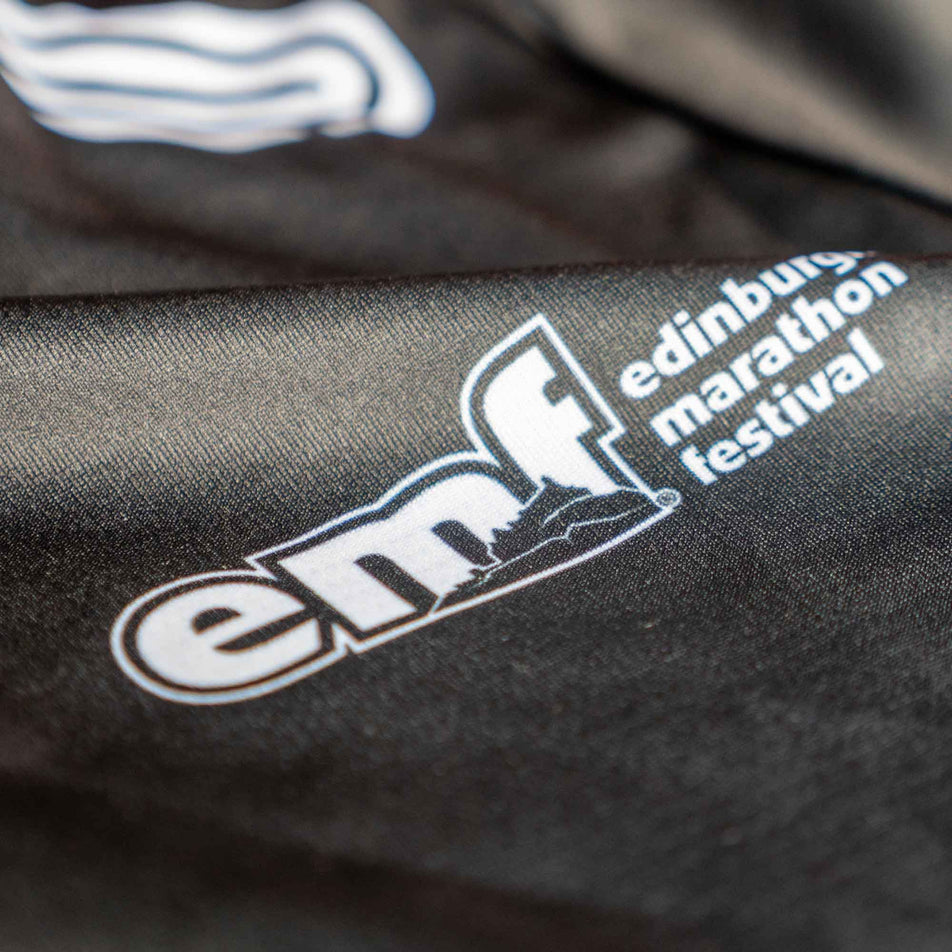 Close-up of the EMF logo on the front of a Pressio Women's Prevail S/S Top from the range of EMF Official Licensed Merchandise (8668982345890)